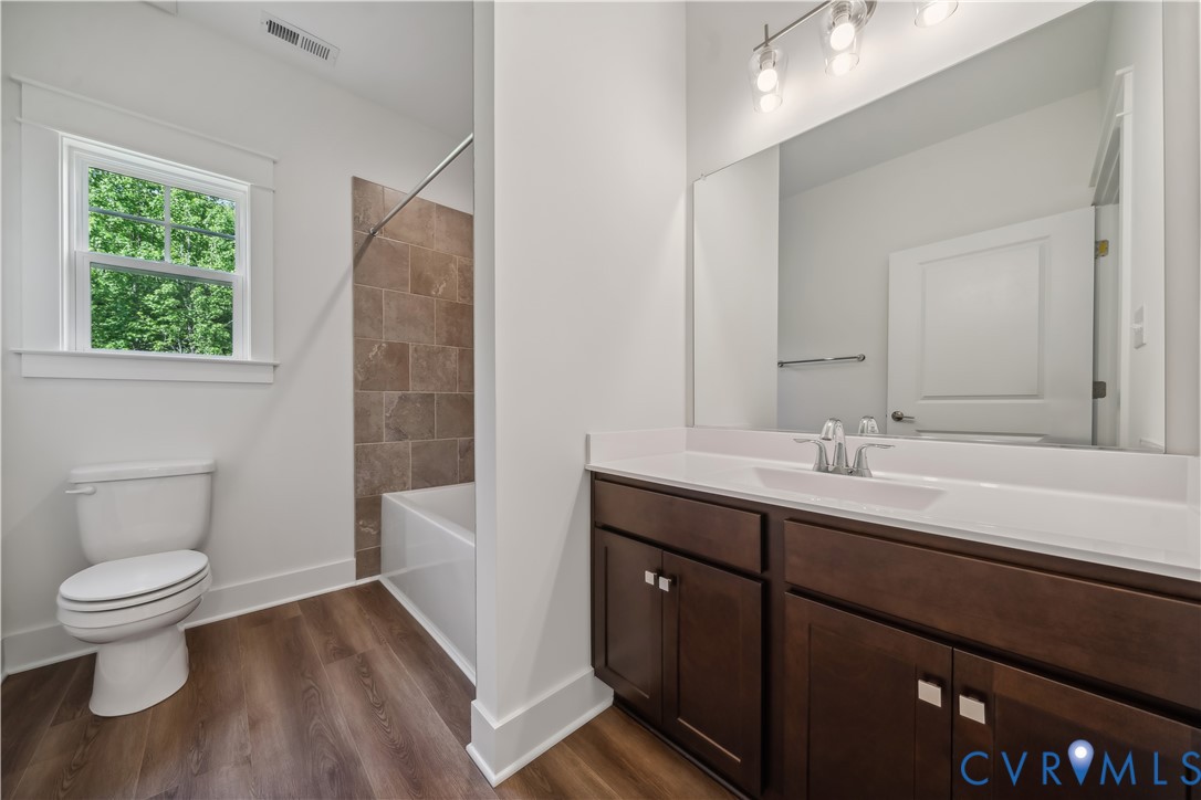 114 Logan Way Tappahannock, VA 22560 - Photo 22 of 28 a bathroom with a toilet sink and mirror