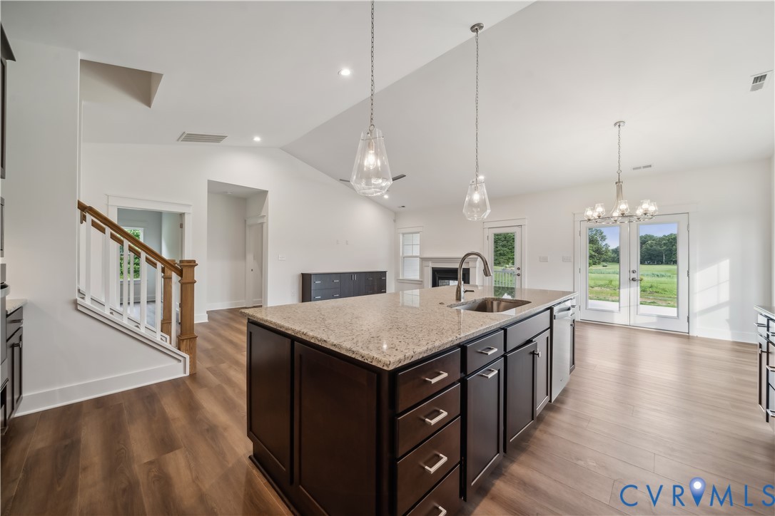 114 Logan Way Tappahannock, VA 22560 - Photo 7 of 28 a kitchen with a stove center island wooden floor appliances and a chandelier