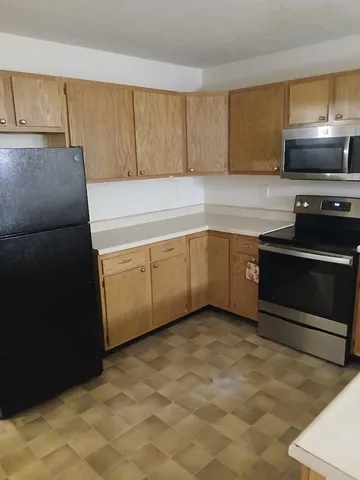 a kitchen with granite countertop a sink and a stove top oven