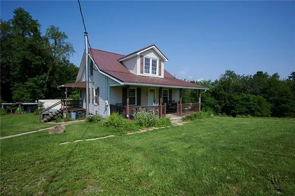 a front view of a house with a yard table and chairs