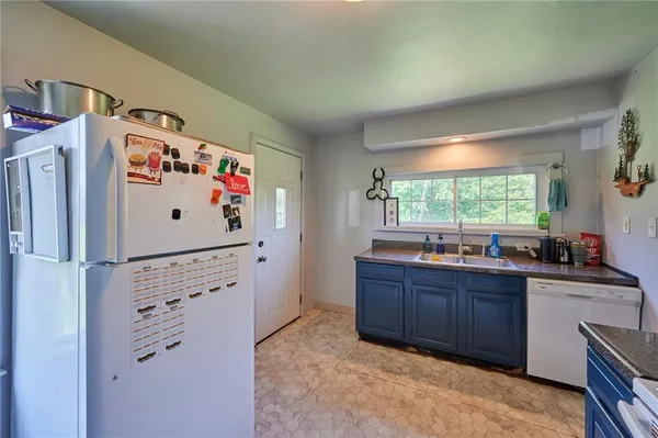 a white refrigerator freezer sitting inside of a kitchen
