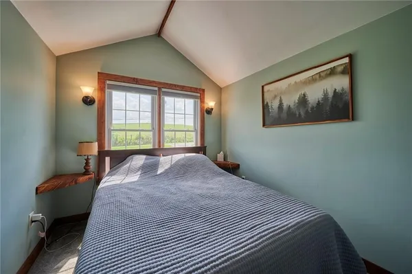 a bedroom with a bed and a window