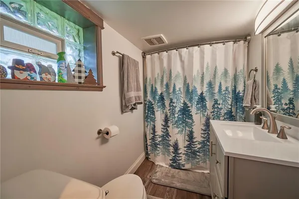 a bathroom with a toilet sink and window