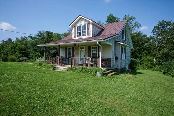 a view of a house with pool and garden