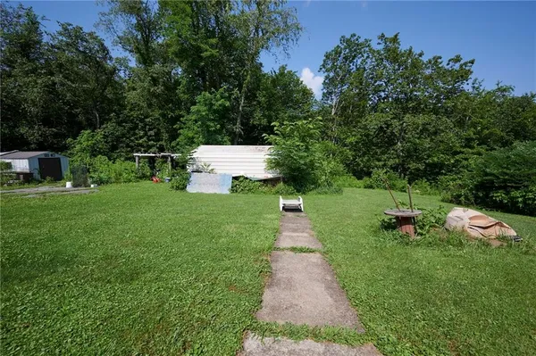 a front view of a house with a yard table and chairs