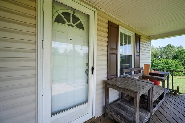 a backyard of a house with barbeque oven table and chairs