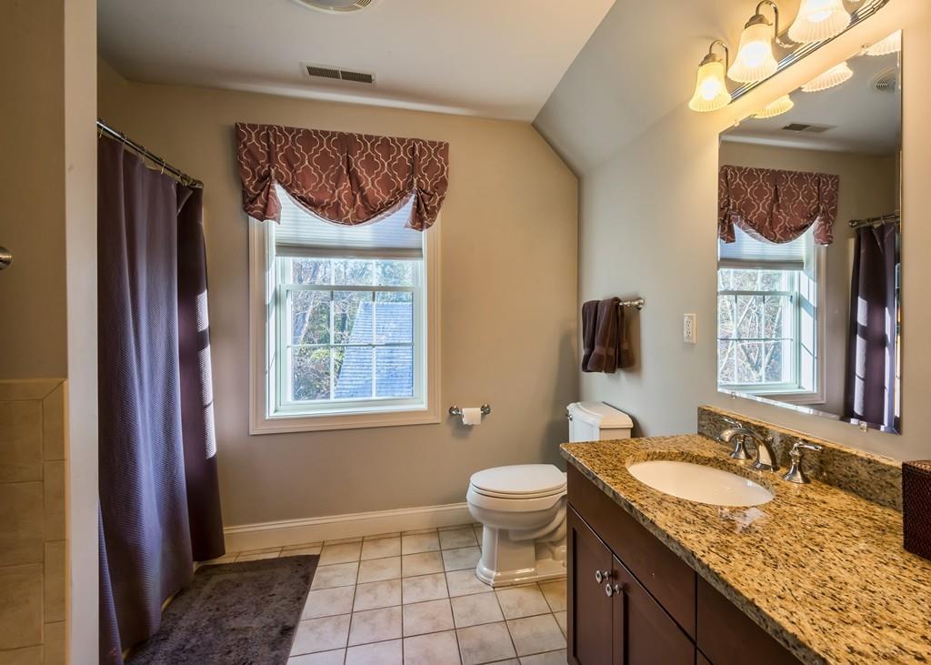 10 Intervale Road Marblehead, MA 01945 - Photo 15 of 32 a bathroom with a granite countertop sink toilet and mirror