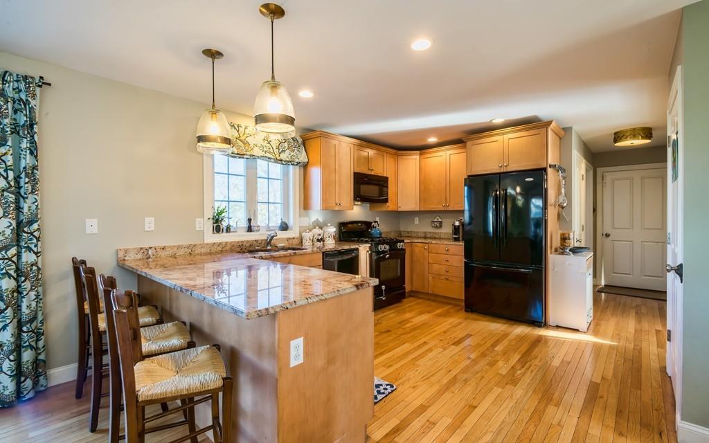 10 Intervale Road Marblehead, MA 01945 - Photo 4 of 32 a kitchen with stainless steel appliances granite countertop a sink a stove and refrigerator