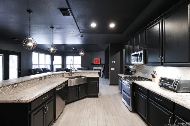 a large kitchen with granite countertop lots of counter top space