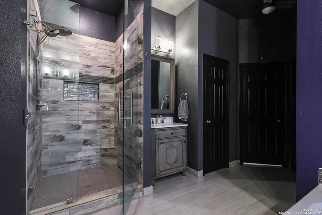 a bathroom with a glass door shower