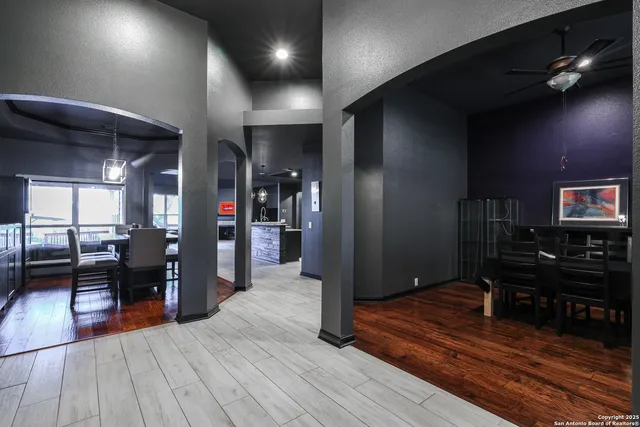 a hallway view with two chair and a large window