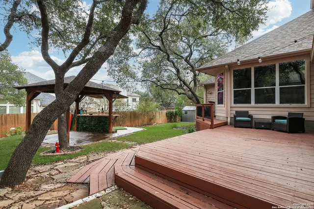 a view of a house with backyard and sitting area