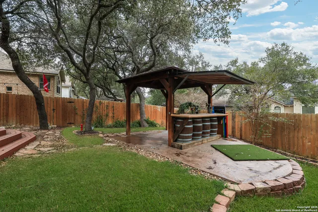 a view of a chairs and backyard with a small cabin