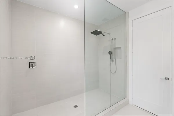 a bathroom with a glass shower door