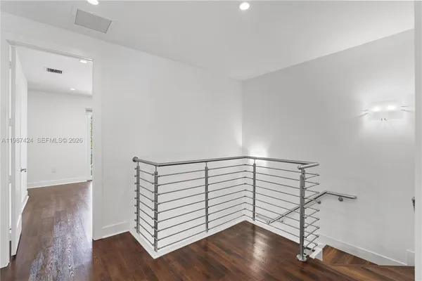 a view of a room with wooden floor