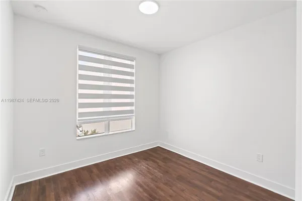 a view of a room with wooden floor and windows