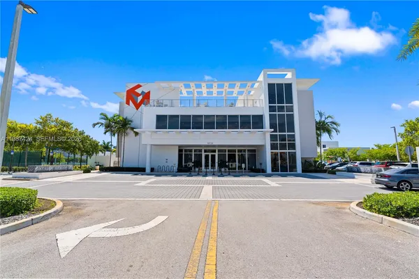 a front view of a building with a garden