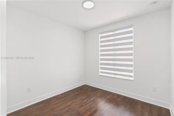 a view of a room with wooden floor and windows