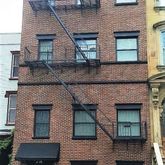 a front view of a building with parking space