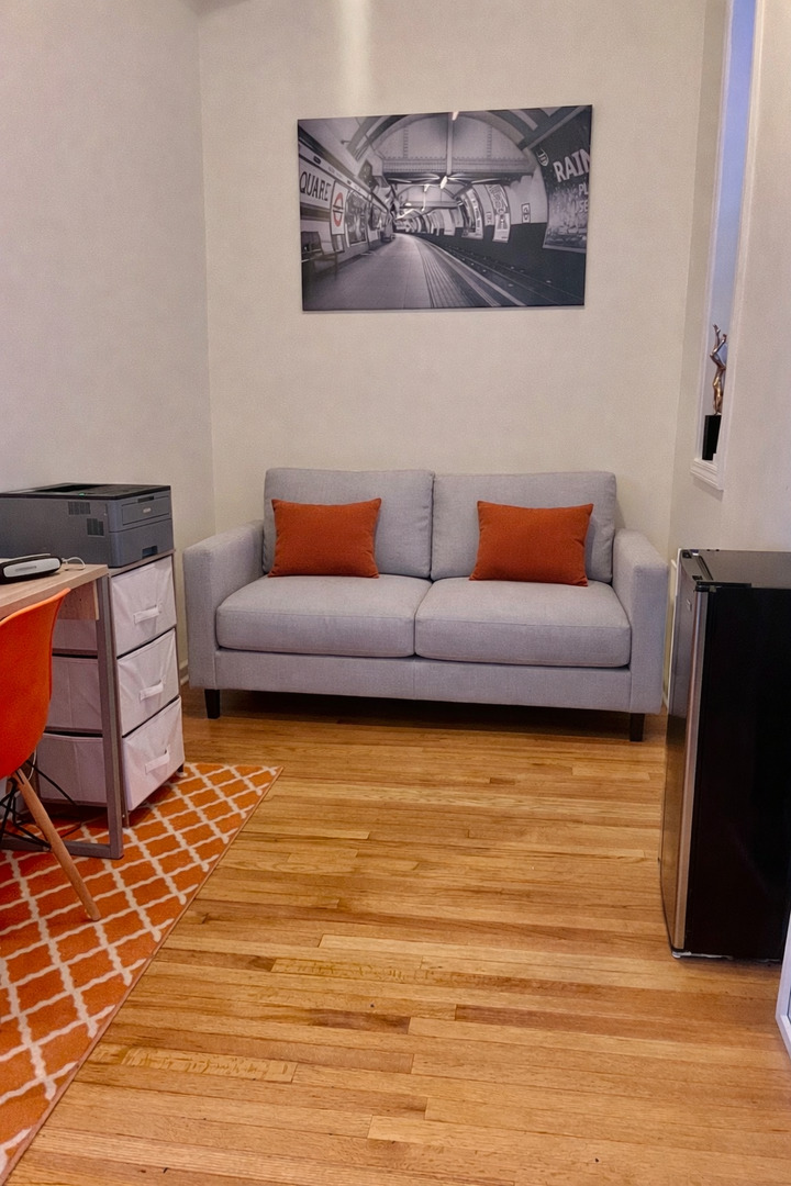 1421 West Huron Street, Unit 2R Chicago, IL 60642 - Photo 16 of 19 a living room with furniture and a flat screen tv