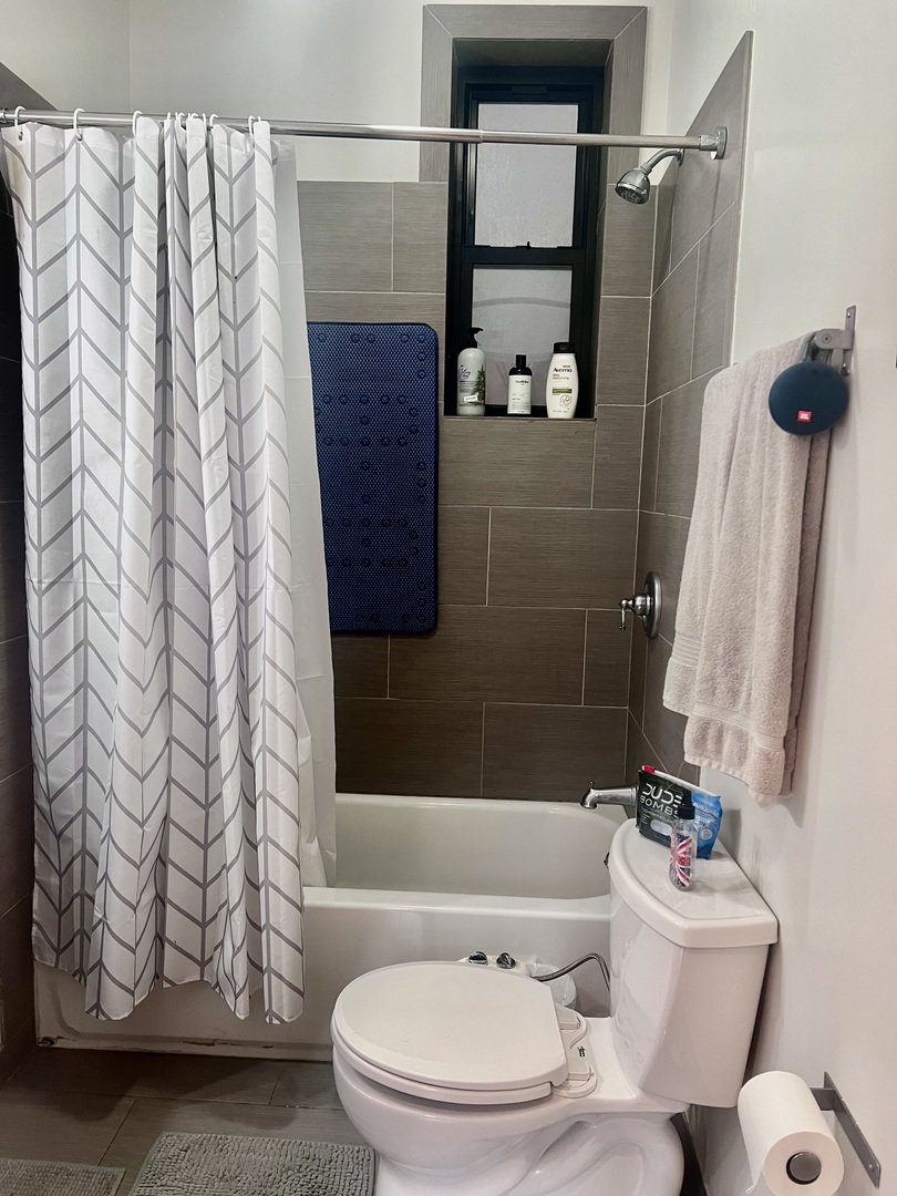 1421 West Huron Street, Unit 2R Chicago, IL 60642 - Photo 17 of 19 a bathroom with a toilet and a shower curtain