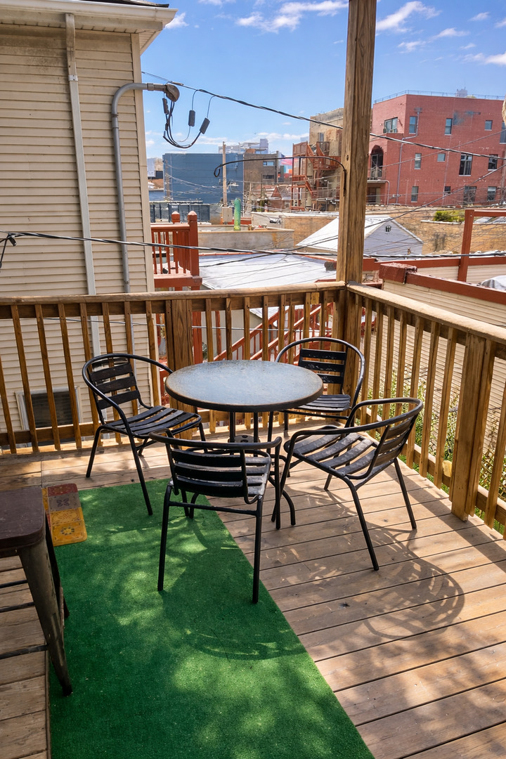1421 West Huron Street, Unit 2R Chicago, IL 60642 - Photo 19 of 19 a view of a chairs and table on the deck