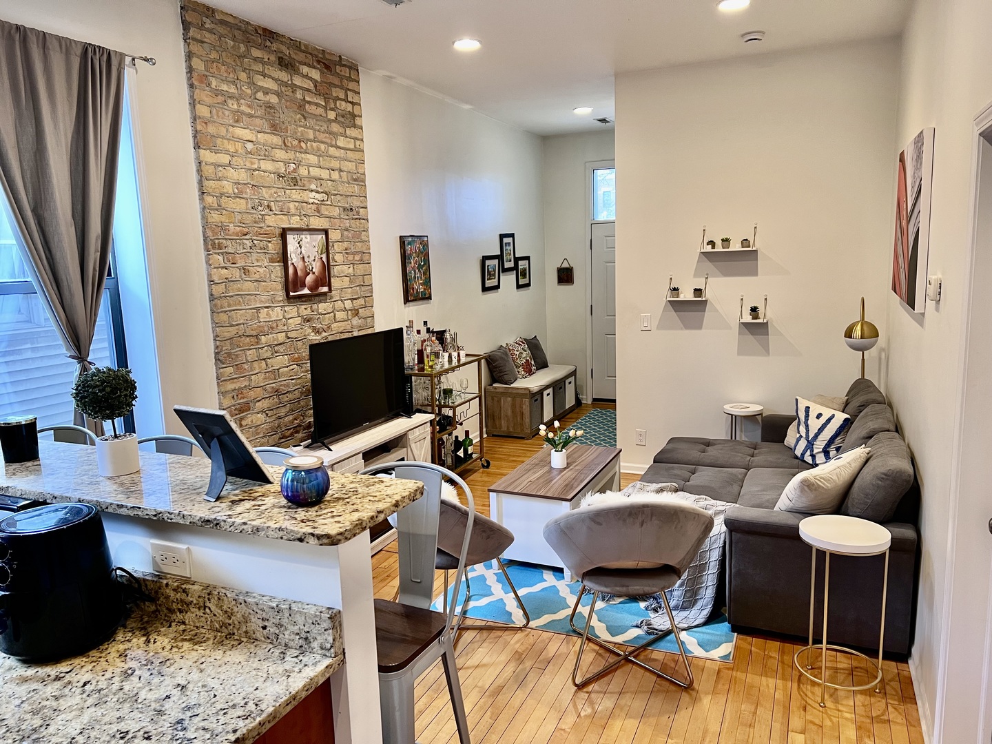 1421 West Huron Street, Unit 2R Chicago, IL 60642 - Photo 2 of 19 a living room with furniture kitchen view and a fireplace