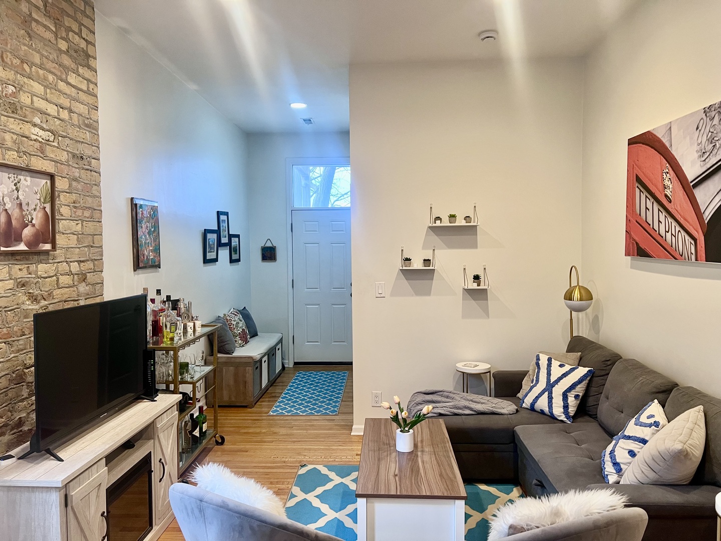 1421 West Huron Street, Unit 2R Chicago, IL 60642 - Photo 5 of 19 a living room with furniture and a flat screen tv