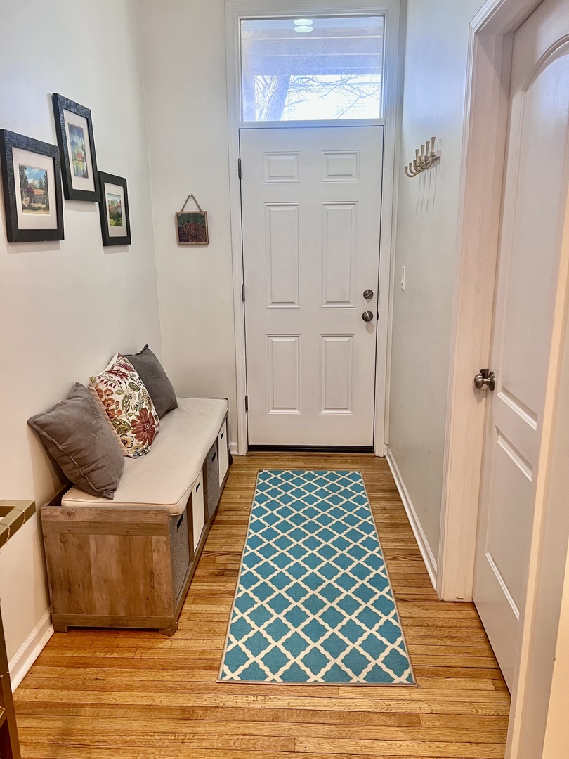 1421 West Huron Street, Unit 2R Chicago, IL 60642 - Photo 9 of 19 a bedroom with a bed and wooden floor