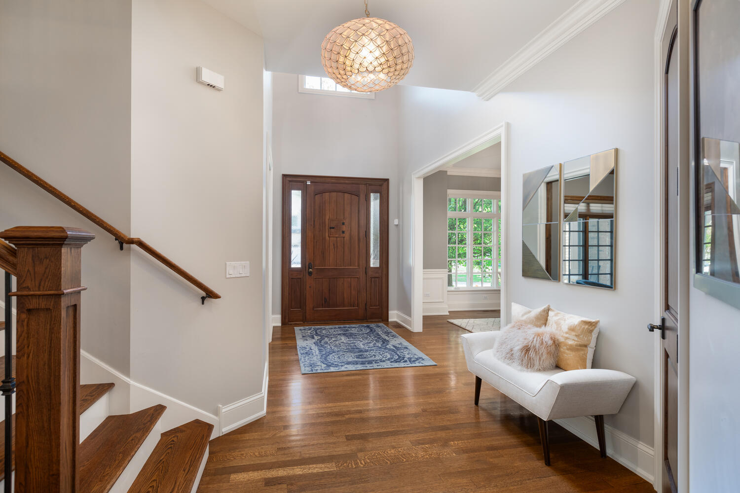 833 Wellner Road Naperville, IL 60540 - Photo 26 of 59 a living room with furniture and a chandelier