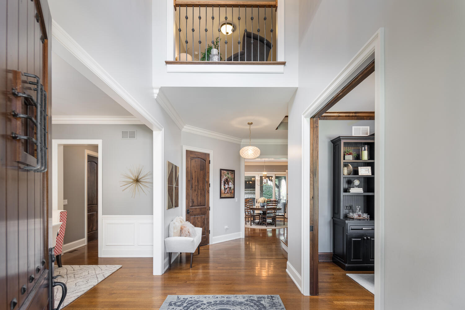 833 Wellner Road Naperville, IL 60540 - Photo 4 of 59 a view of a hallway with wooden floor and dining room