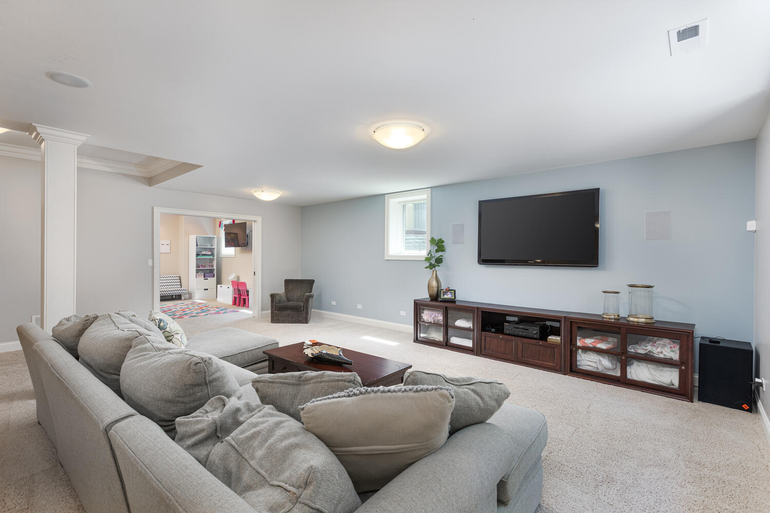 833 Wellner Road Naperville, IL 60540 - Photo 46 of 59 a living room with furniture and a flat screen tv