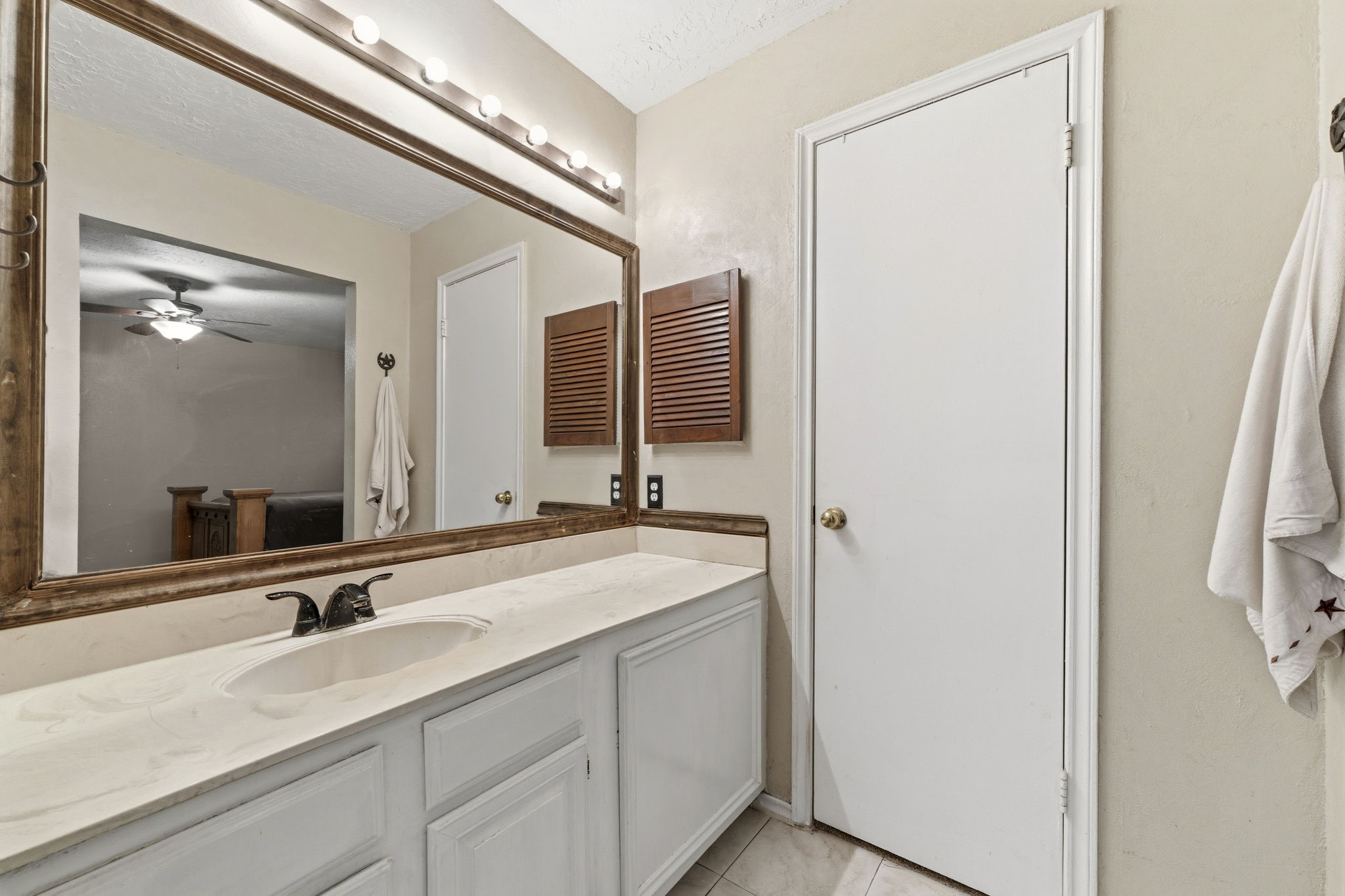 5603 Lynngate Drive Spring, TX 77373 - Photo 18 of 35 Primary bath vanity area, door leads to walk in closet