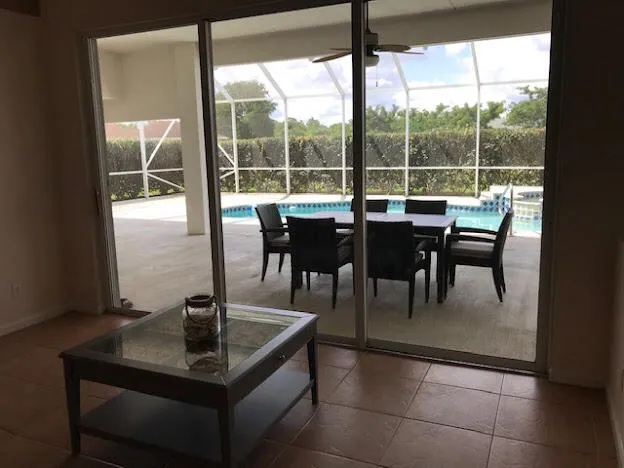 a view of a dining room with a table and chairs