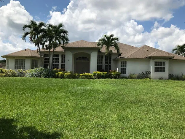 a front view of house with yard and green space