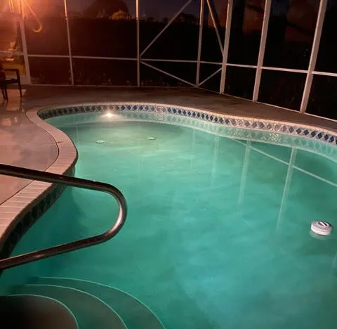 a view of a swimming pool with deck