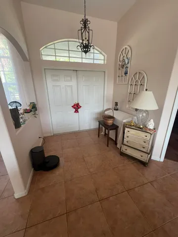 a room with gym equipment and a chandelier