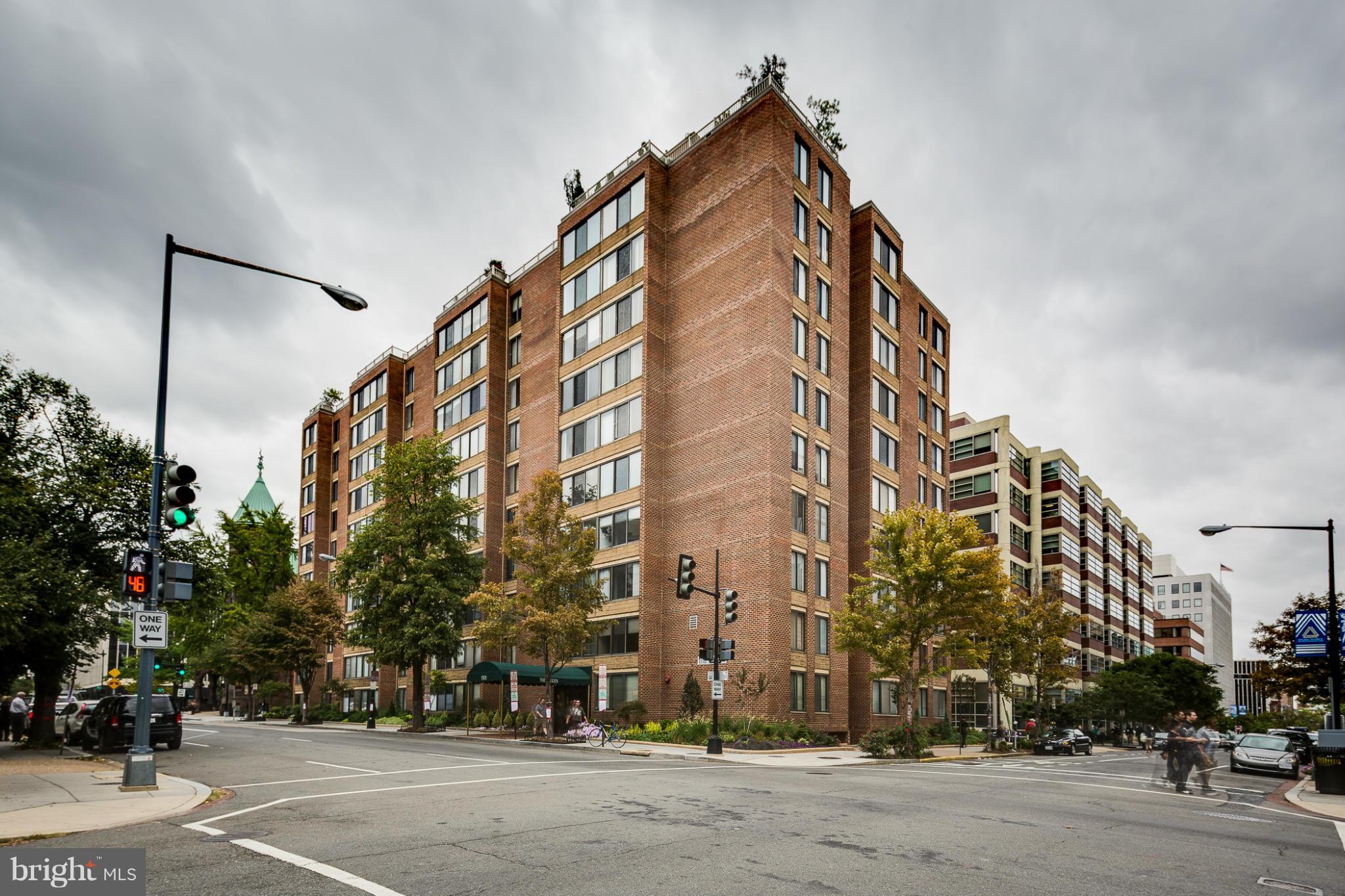 a view of a tall building next to a road