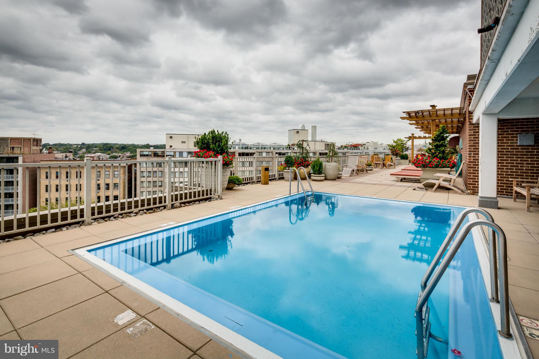 1301 20th Street Northwest, Unit 117 Washington, DC 20036 - Photo 11 of 16 a view of a swimming pool with a lounge chair
