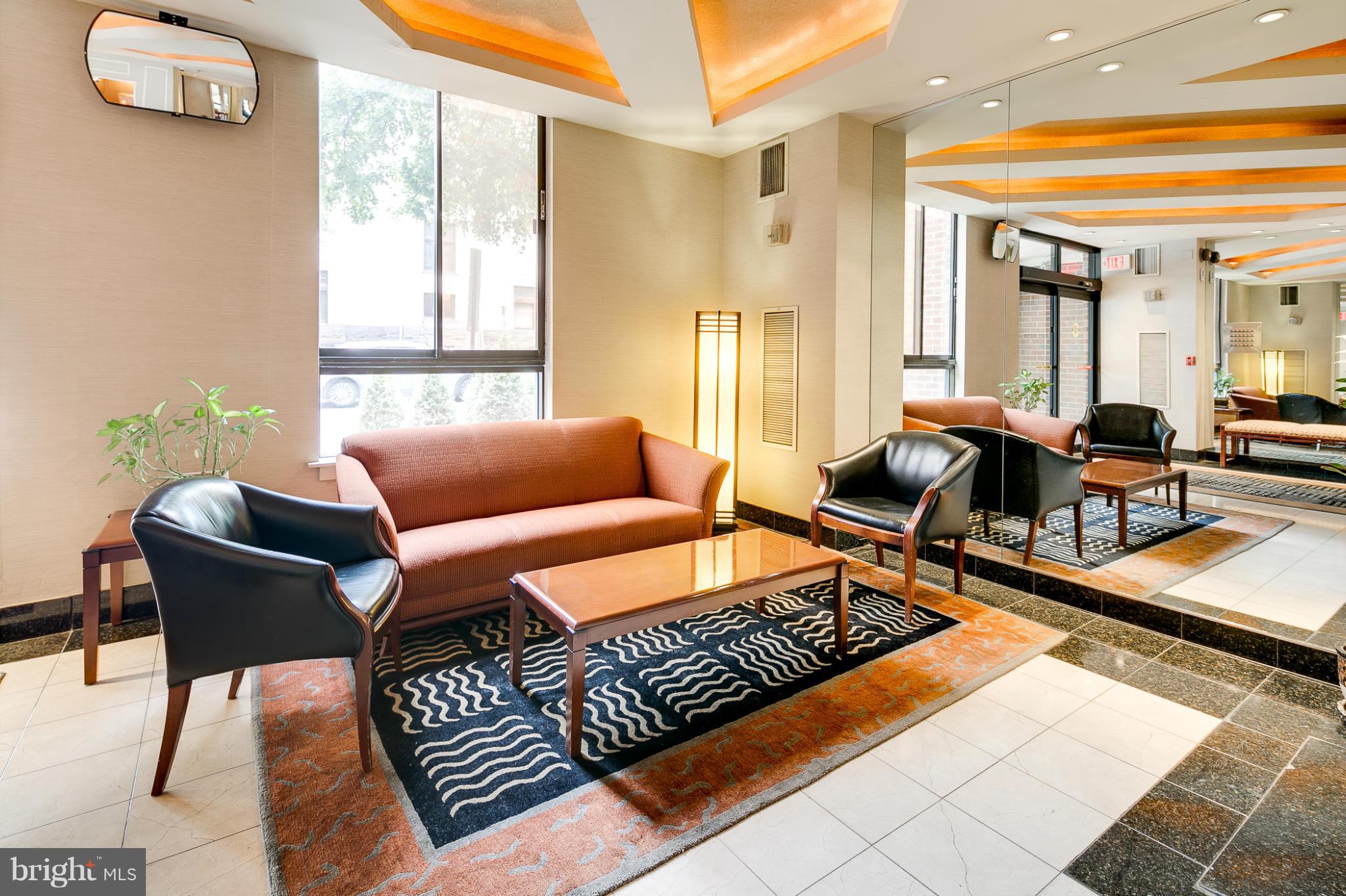 1301 20th Street Northwest, Unit 117 Washington, DC 20036 - Photo 3 of 16 a living room with furniture and a window