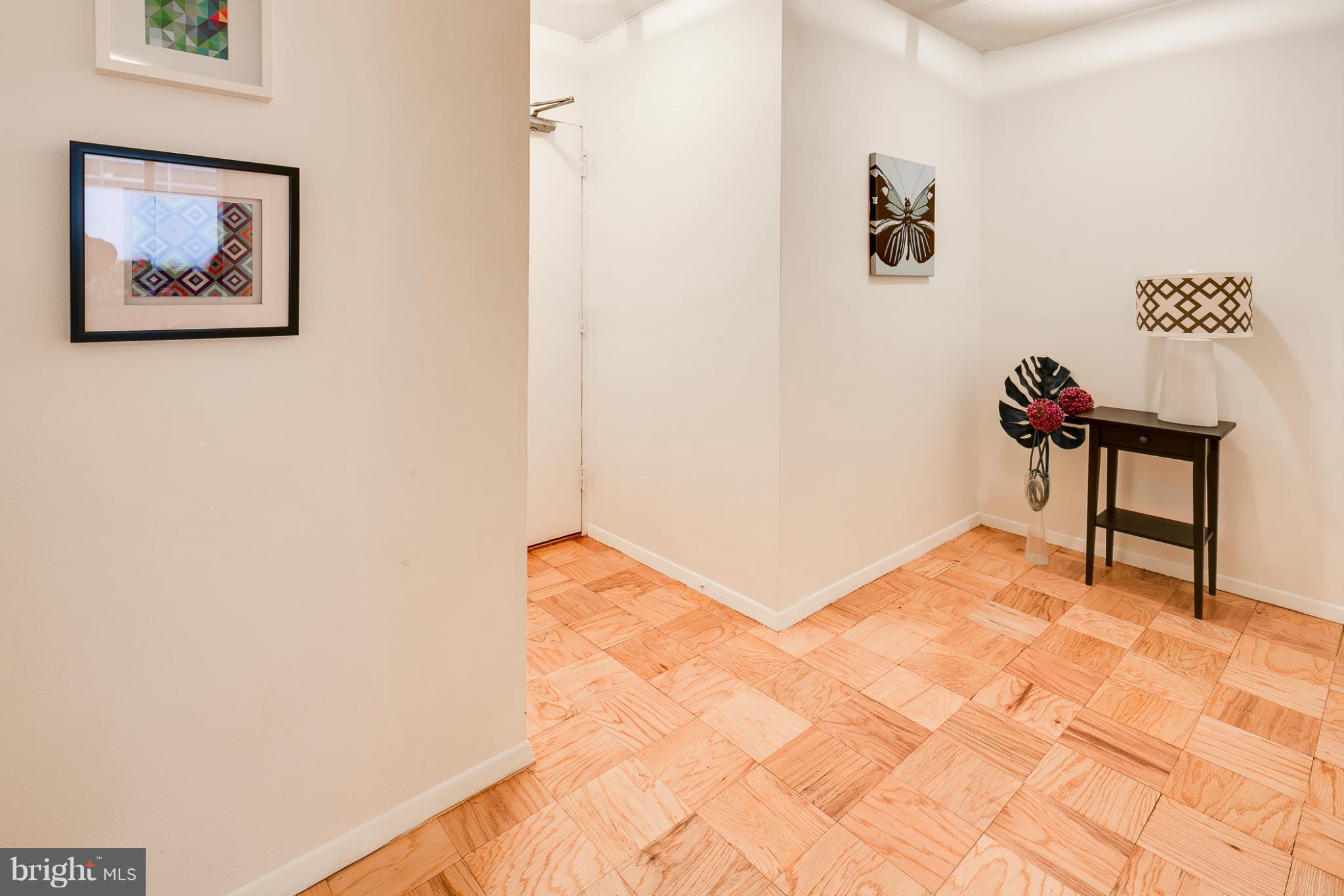 1301 20th Street Northwest, Unit 117 Washington, DC 20036 - Photo 4 of 16 a view of a hallway with paintings on the wall