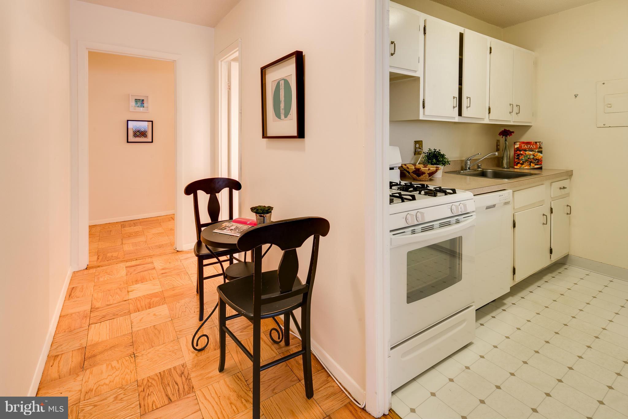 1301 20th Street Northwest, Unit 117 Washington, DC 20036 - Photo 5 of 16 a kitchen with stainless steel appliances a stove a sink and a refrigerator
