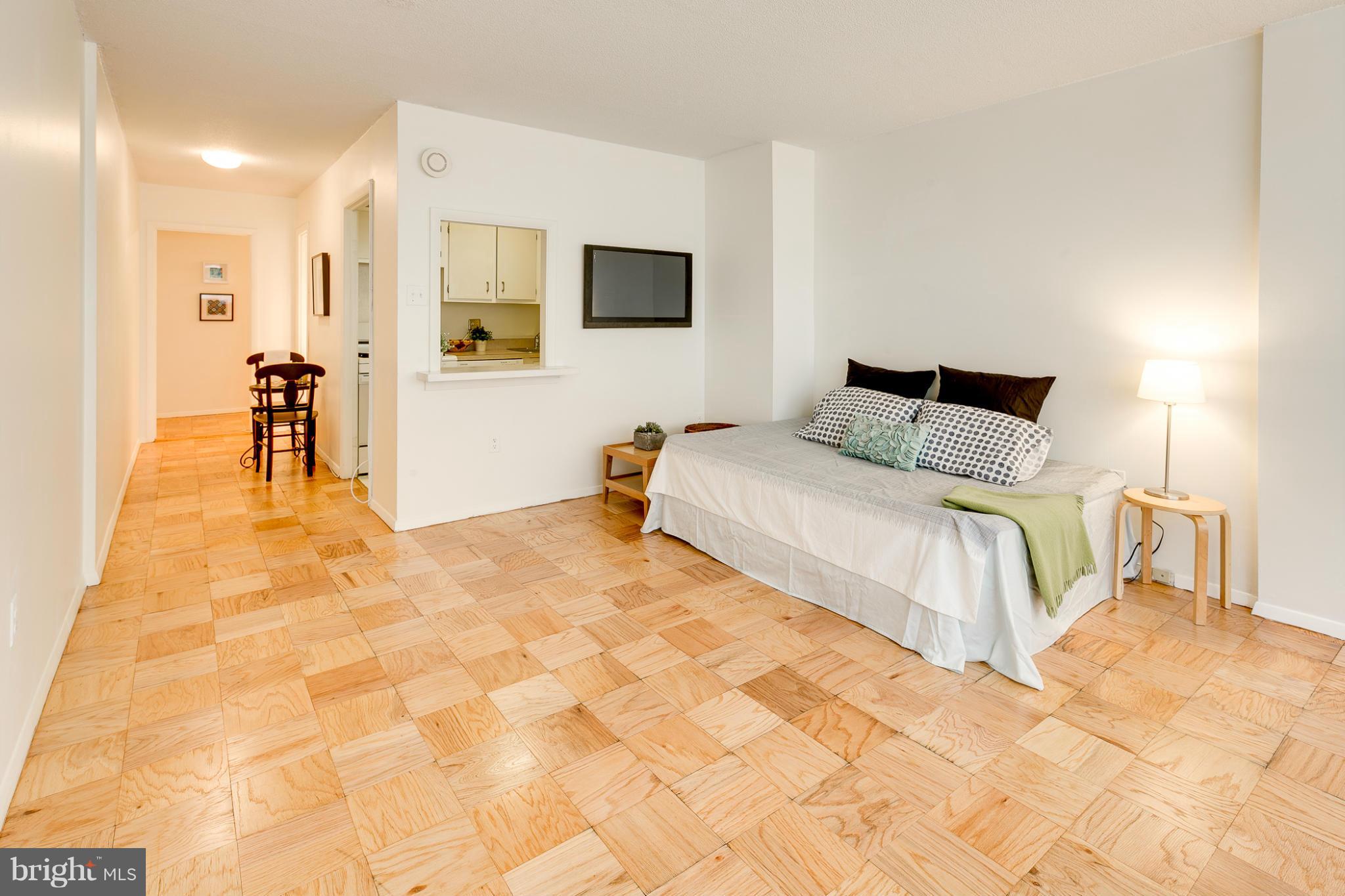 1301 20th Street Northwest, Unit 117 Washington, DC 20036 - Photo 6 of 16 a bedroom with a bed and a flat screen tv