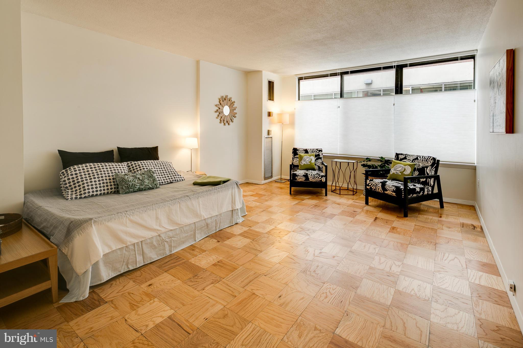 1301 20th Street Northwest, Unit 117 Washington, DC 20036 - Photo 7 of 16 a bedroom with a bed and with furniture