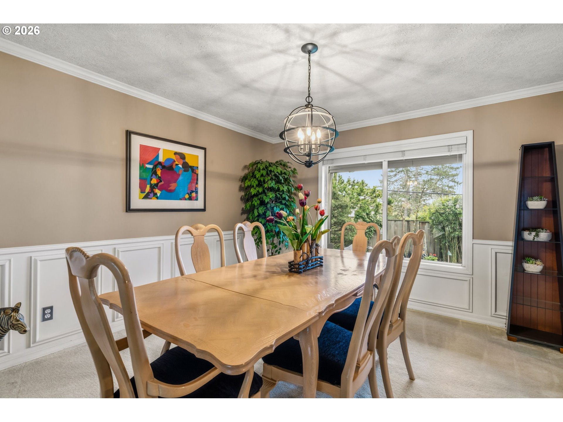 6108 Southwest Kruse Ridge Drive Portland, OR 97219 - Photo 6 of 42 a view of a dining room with furniture a chandelier and wooden floor