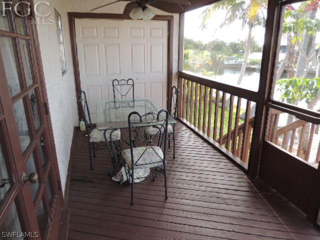 3197 Stabile Road St. James City, FL 33956 - Photo 11 of 17 a view of a hallway with wooden floor and stairs