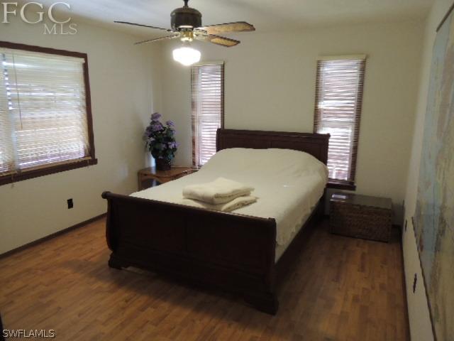 3197 Stabile Road St. James City, FL 33956 - Photo 15 of 17 a bed sitting in a bedroom next to a window