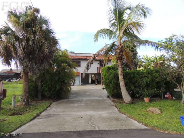 3197 Stabile Road St. James City, FL 33956 - Photo 3 of 17 a view of a street with a building and a palm tree