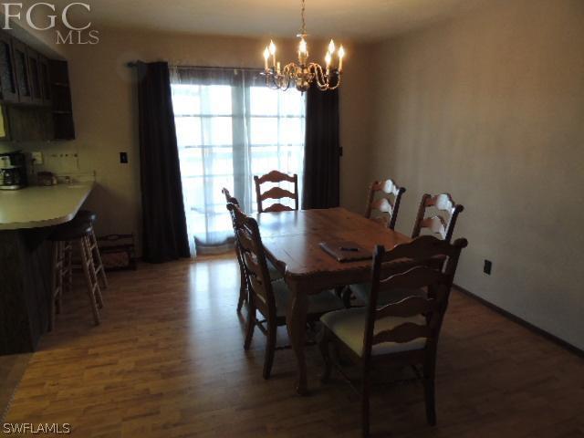 3197 Stabile Road St. James City, FL 33956 - Photo 9 of 17 a view of a dining room with furniture window and wooden floor