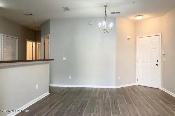 a view of a room with wooden floor and window